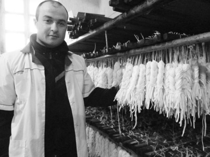 Технолог Эльдар Сурманидзе со свежесваренным сыром. Фото Зои ТЮРИНОЙ.