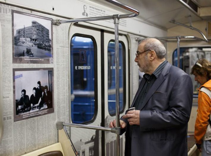 Владимир Калужский рассматривает фотографии, размещенные на стенах вагона. Фото Геннадия ДАНИЛКИНА